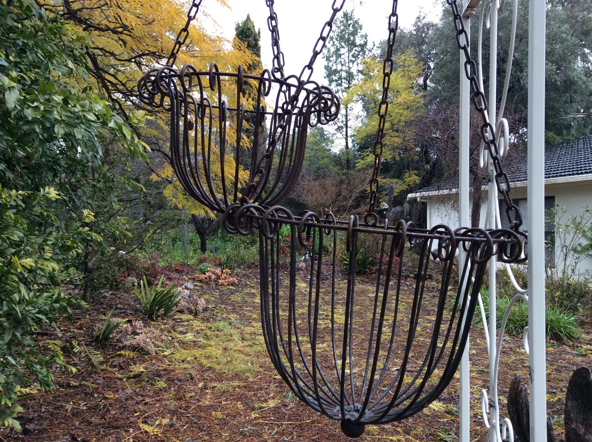  Set of two rusty hanging handled baskets